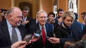 Media surround Senate Majority Leader Mitch McConnell.