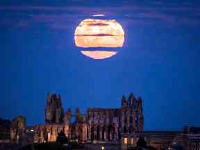 The moon rises over Whitby Abbey in Yorkshire