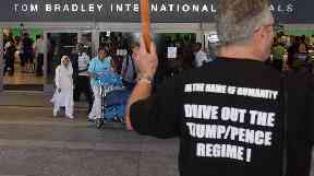 Demonstrators greet travelers arriving at Los Angeles International Airport.
