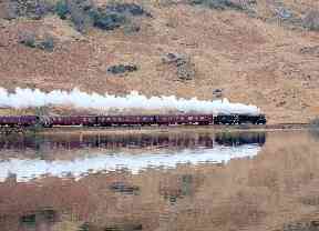 The famous 'Harry Potter train' travels alongside Loch Eilt near Glenfinnan.