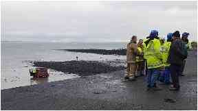 Rescue: The pensioner's car ended up on the beach.
