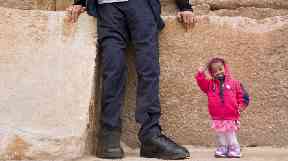 Jyoti Amage stands next to the legs of the world's tallest man.
