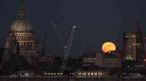 A super moon rises over the City of London.