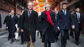 Prime Minister Theresa May and her husband Philip walk through a market after visiting the Yu Yuan Temple Garden in Shanghai.
