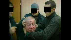 Mr Skripal being arrested by Russian security personnel.