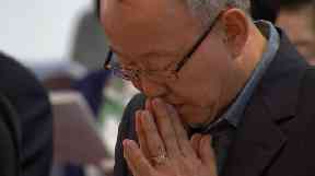 A member of Seoul's Anglican cathedral praying for peace and unity.