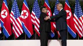 Kim Jong-un and Donald Trump share a historic handshake.