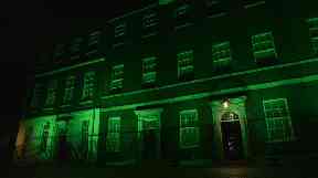 Downing Street in London is illuminated in green to mark a year since the Grenfell tragedy.