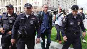 Peter Tatchell is led away by Russian police (Aaron Chown/PA)