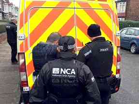 Officers during a raid in a major operation aimed at tackling people smuggling