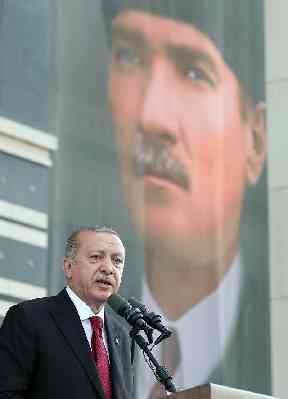 Turkey’s President Recep Tayyip Erdogan, backdropped by a poster of modern Turkey founder Mustafa Kemal Ataturk