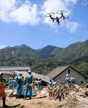 Rescuers use a drone during a search operation for missing people