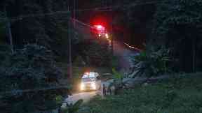 Two ambulances with flashing lights leaves the cave rescue area on Monday
