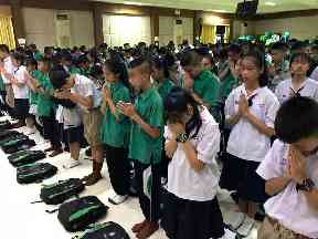 Students pray at Maesaiprasitsart school where six of the rescued boys study