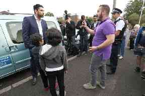 People with opposing views have a discussion near Boris Johnson’s office as police look on