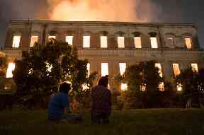 People watch as flames engulf the 200-year-old National Museum of Brazil