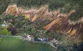 Houses are destroyed by a landslide after an earthquake in Atsuma town, Hokkaido, northern Japan