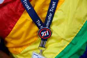 An activist wears a badge protesting against section 377 of the law