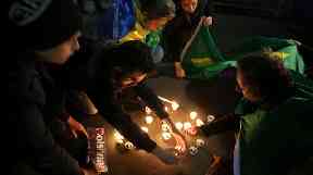 People light candles in support of Jair Bolsonaro.