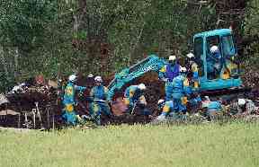 Rescuers at the site of a landslide in Atsuma town