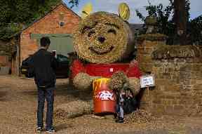 A Winnie the Pooh scarecrow charms visitors to the annual Harpole Scarecrow Festival