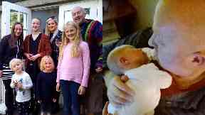 Family man: Tim Porteus with his family and holding baby Lewis.