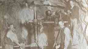 Workers with a tunnelling machine.