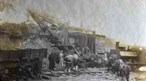 A steam engine brings material to the works.
