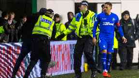 Pitch invader: Rangers captain James Tavernier looks on.
