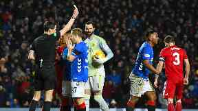 Booked: Referee Kevin Clancy shows Alfredo Morelos a yellow card.
