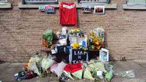 Tribute: Classmates at Westhill Academy left flowers, pictures and a football tops.
