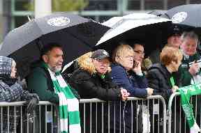 Farewell: Fans line the streets in the rain.