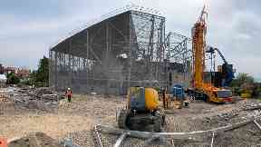 Protection: Construction workers erecting the steel frame.