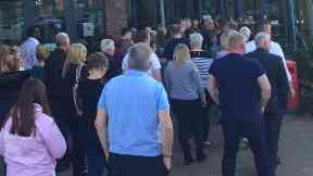 Parents queue to get into the public meeting.