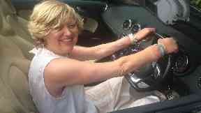 Raring to go: Ms Hutton behind the wheel of her car with her new hands.