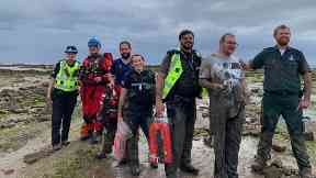 Heroes: The muddy rescuers with the Texan.