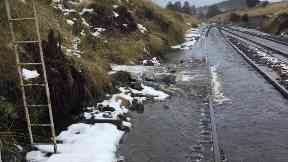Heavy flooding has forced the rail line's closure.